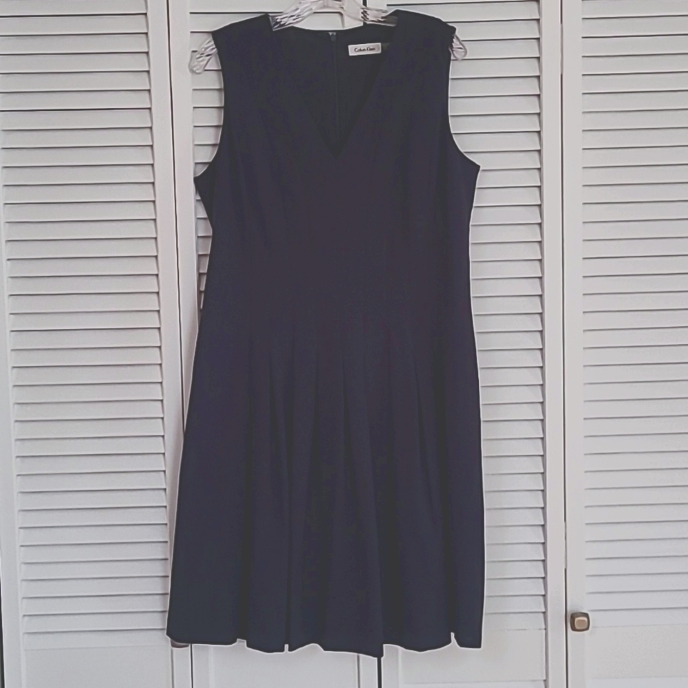 Calvin Klein navy dress, fitted top with pleating and flair, size 12